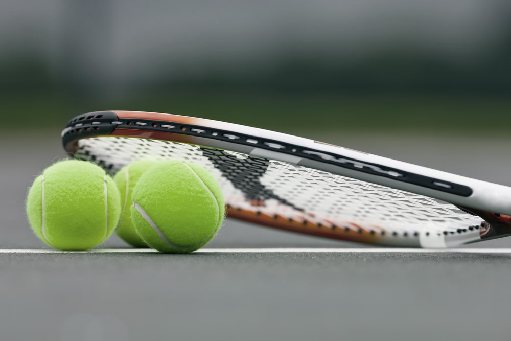 Meonstoke Tennis Club - a tennis balls and racquet on court